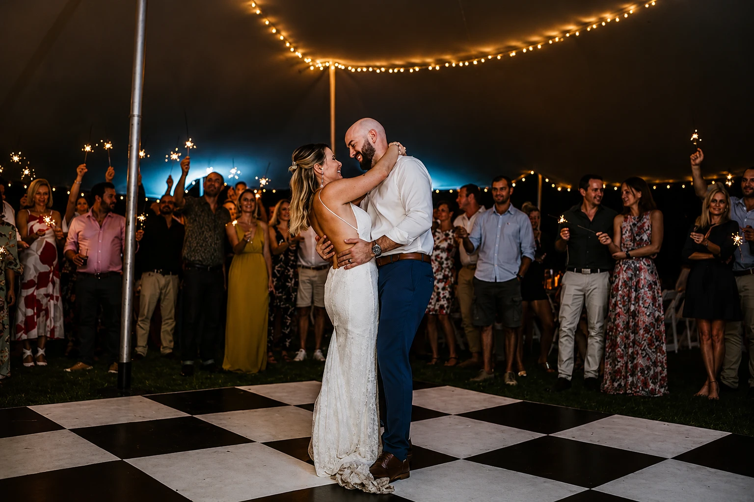 Bride and groom sharing their first dance surrounded by guests holding sparklers at a South Coast KZN wedding celebration
